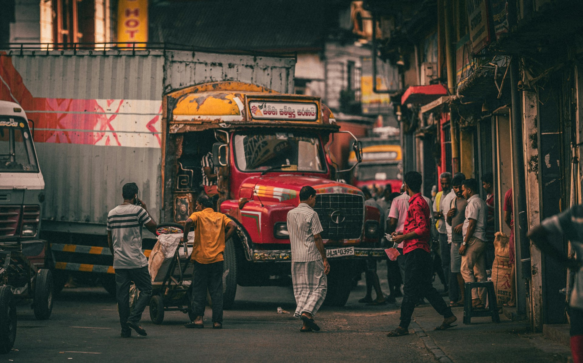 a group of people standing around a truck