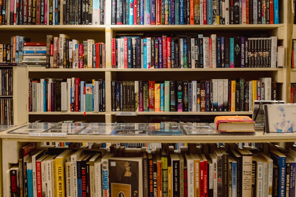 a bookshelf filled with lots of books and dvds