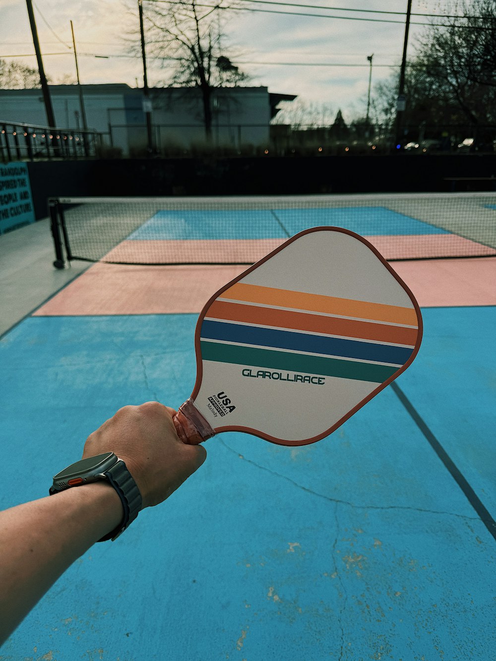 a person holding a paddle on a tennis court