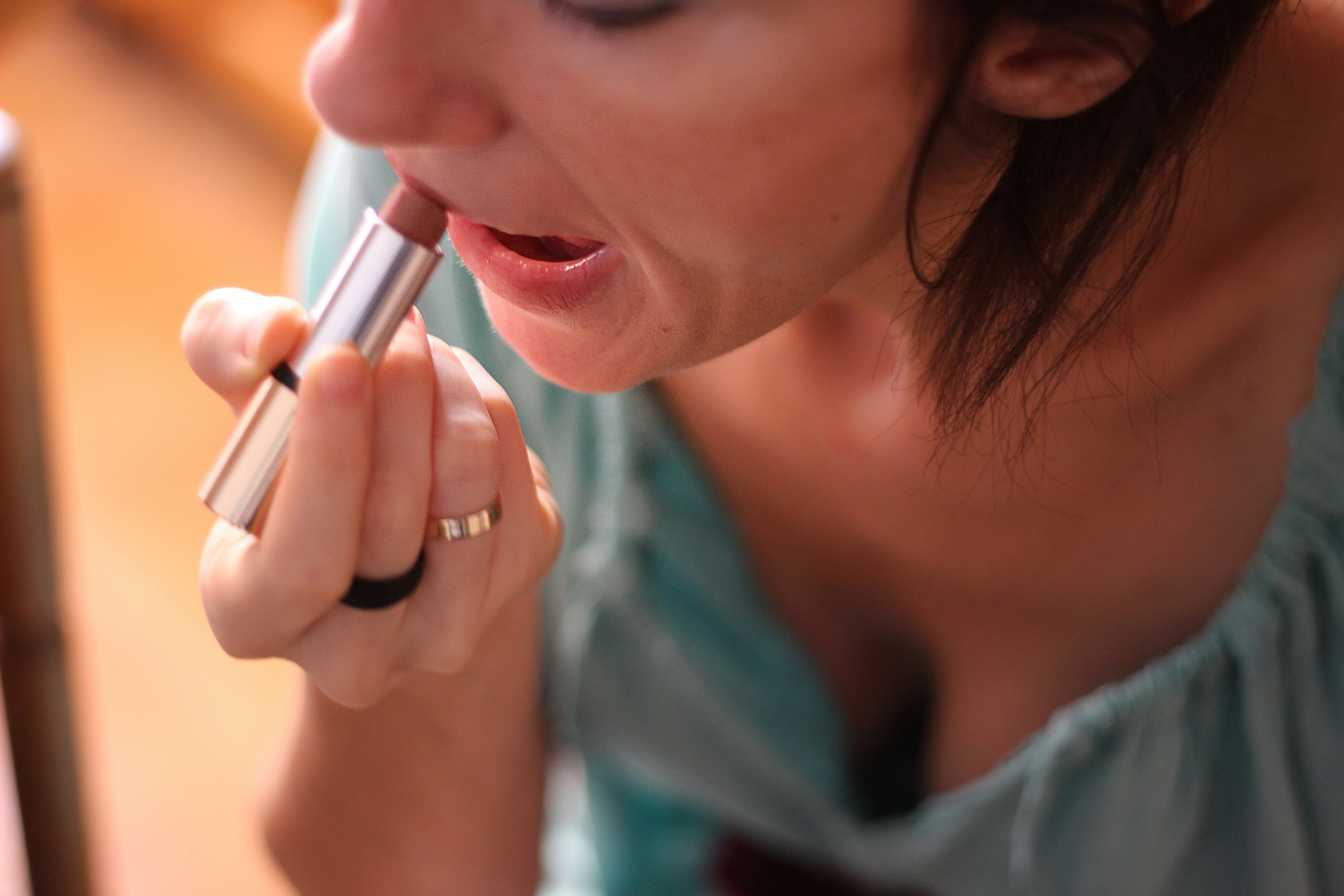 A woman is holding a pen in her mouth