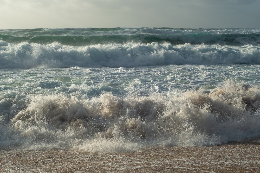 a large body of water next to a sandy beach