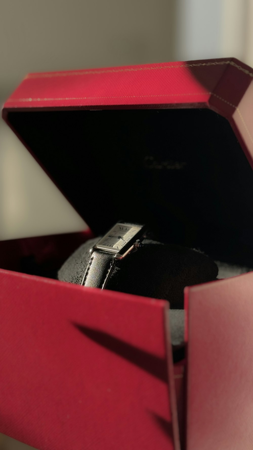 a red box with a watch inside of it