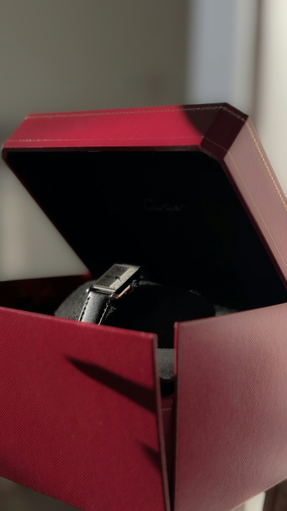 a watch inside of a red box on a table