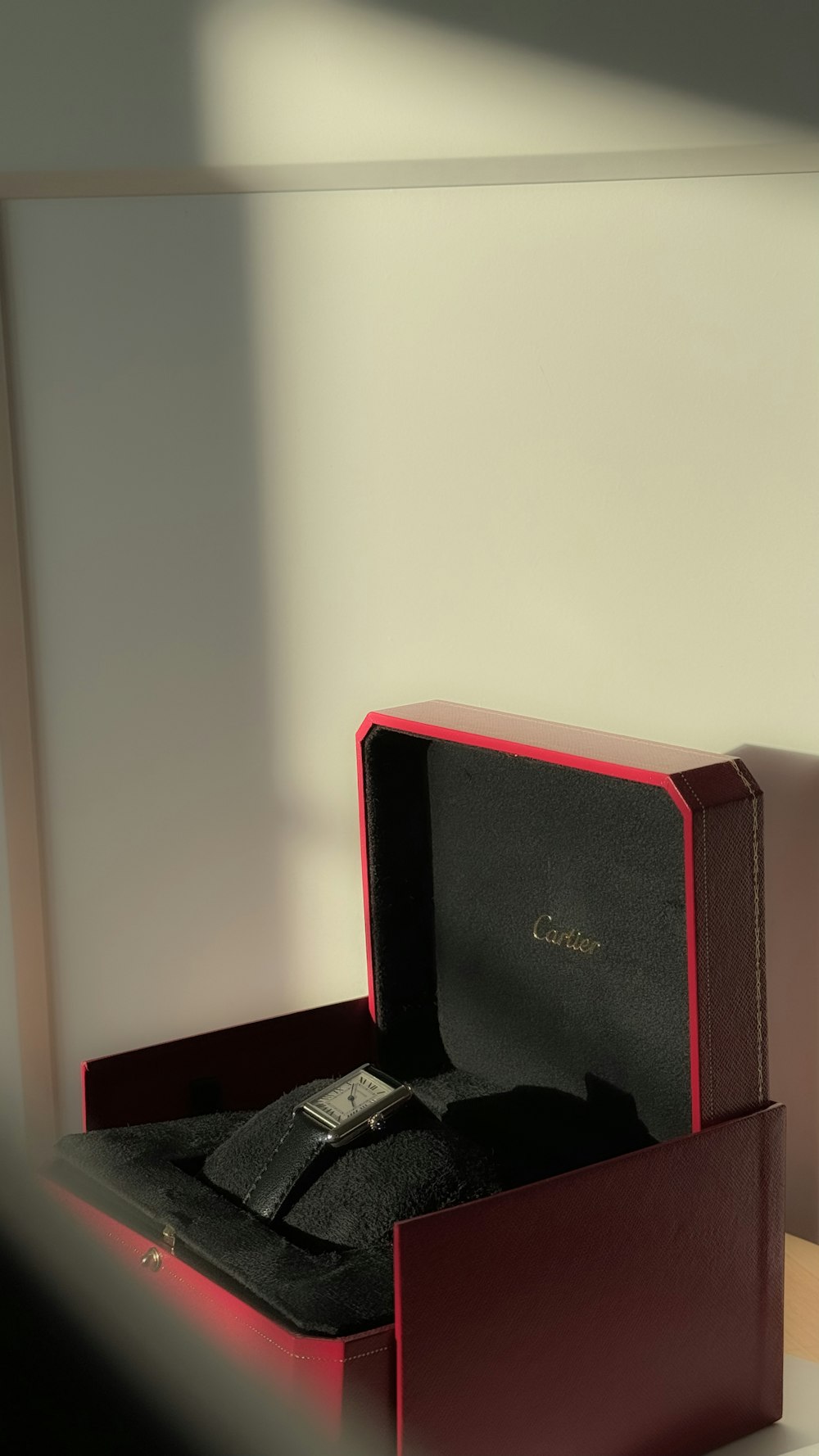 a watch in a red box on a table