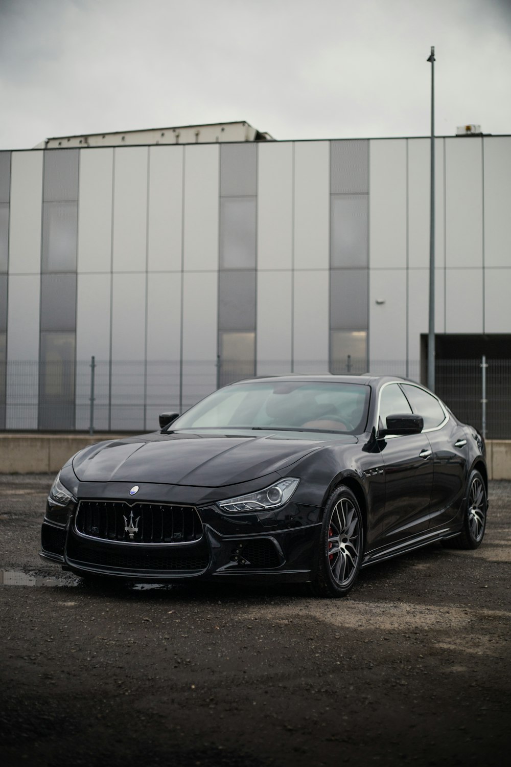 a black masera parked in front of a building