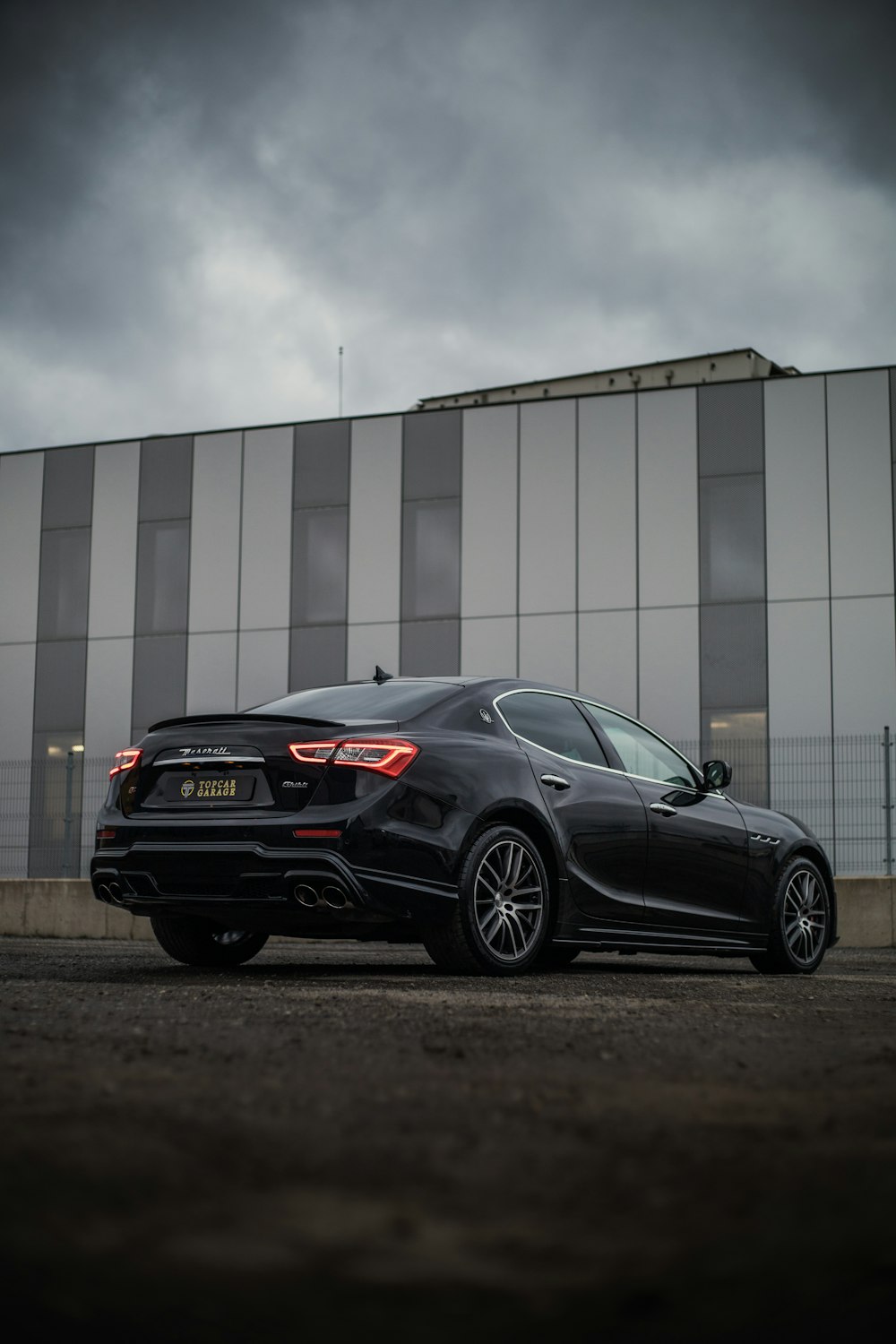 a black sports car parked in front of a building