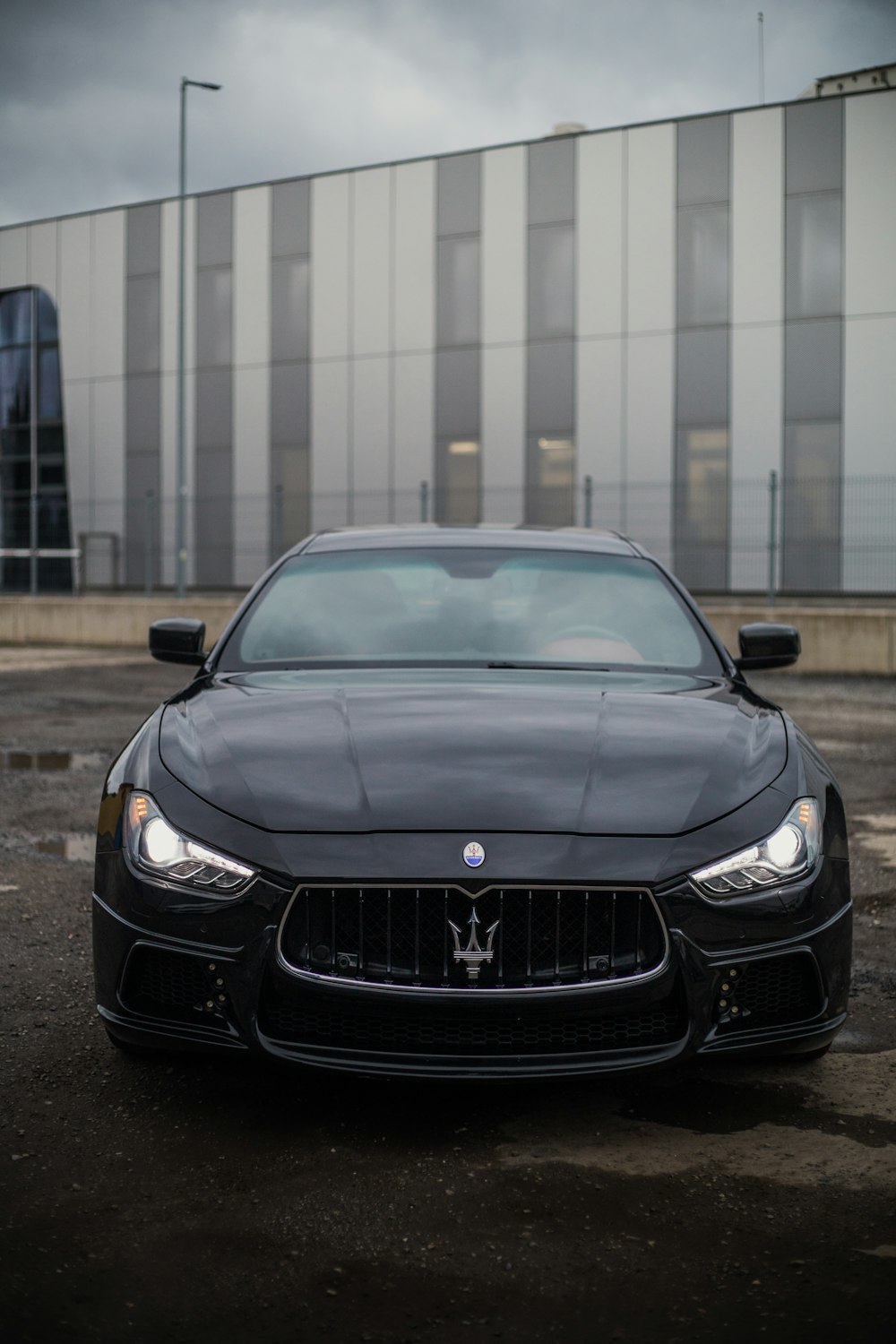 a black masera parked in front of a building