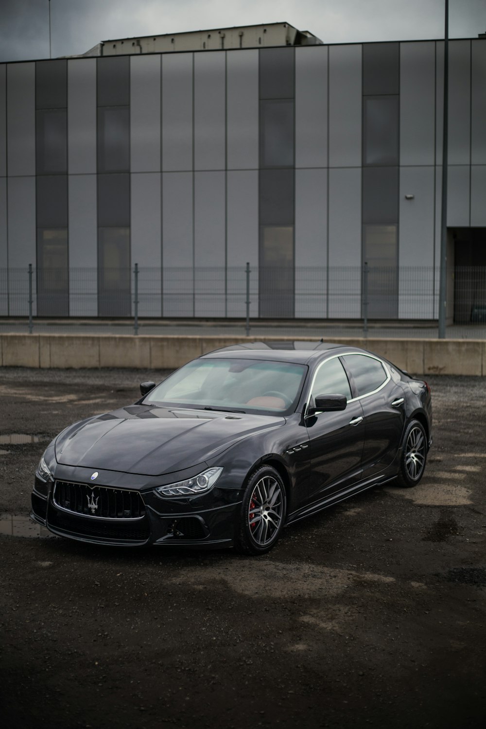 a black masera parked in front of a building