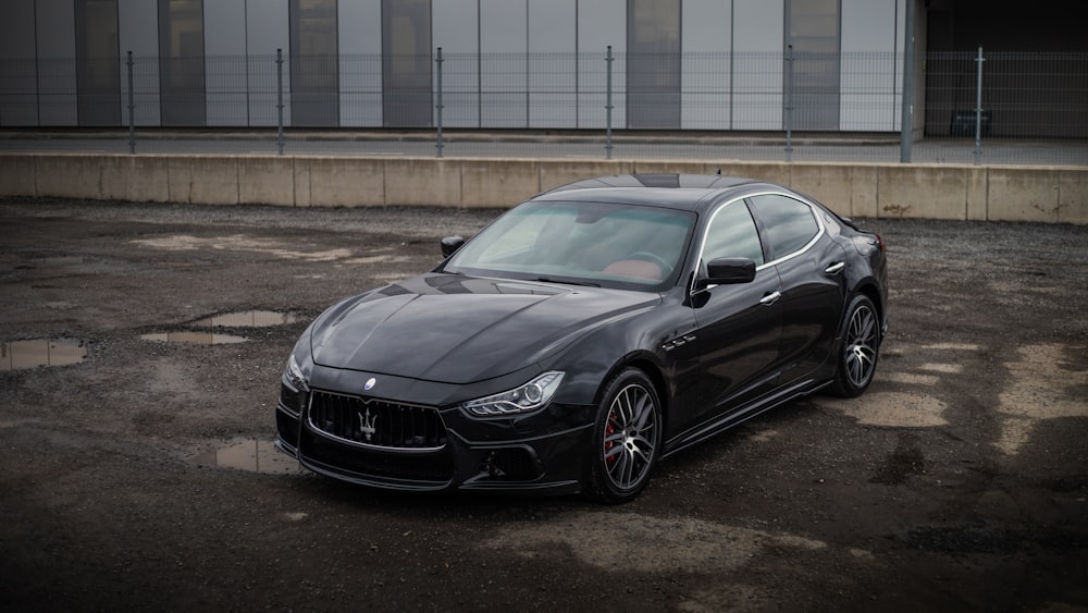 a black masera is parked in a parking lot