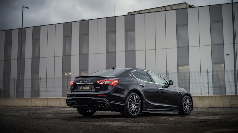 a black car parked in front of a building