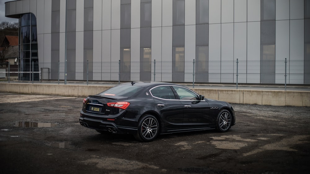 a black car parked in front of a building