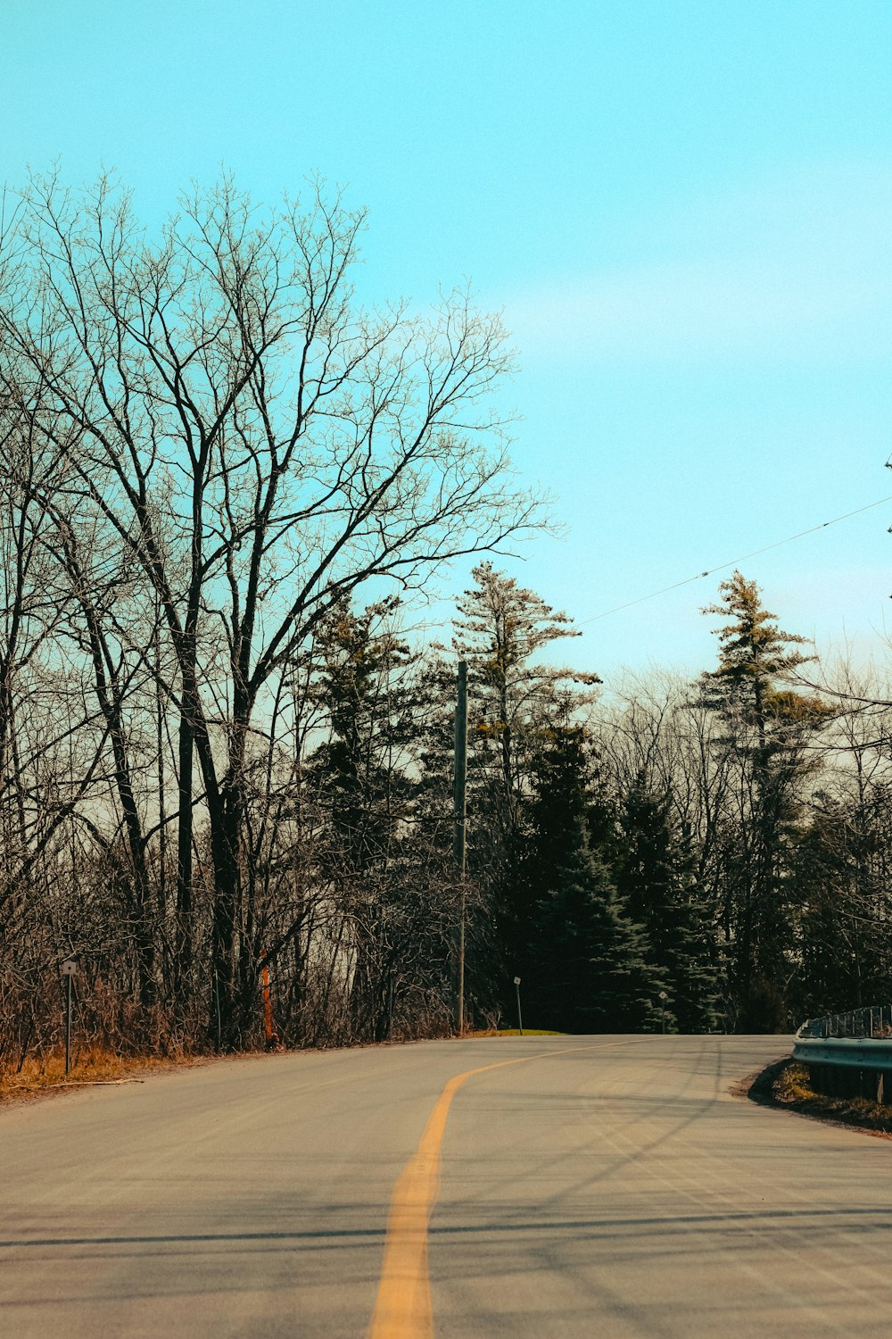 an empty road with a stop sign on the side of it