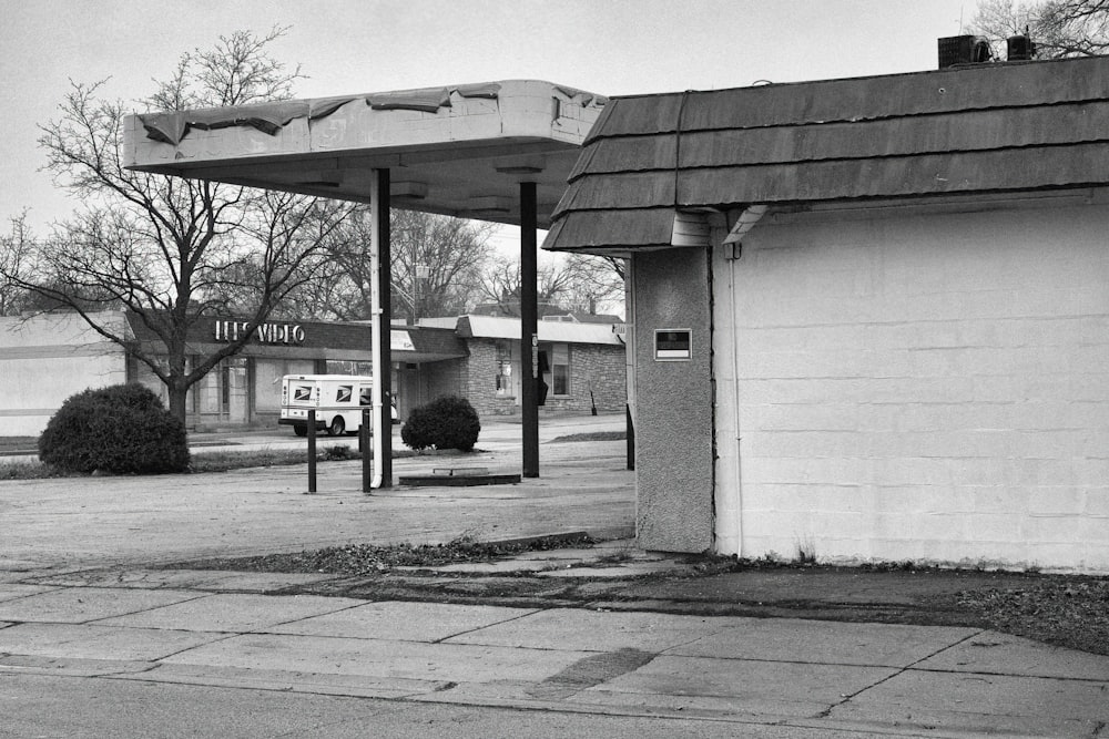 a black and white photo of a gas station