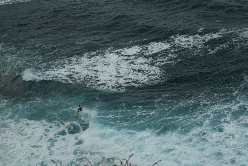 a person riding a wave on top of a surfboard