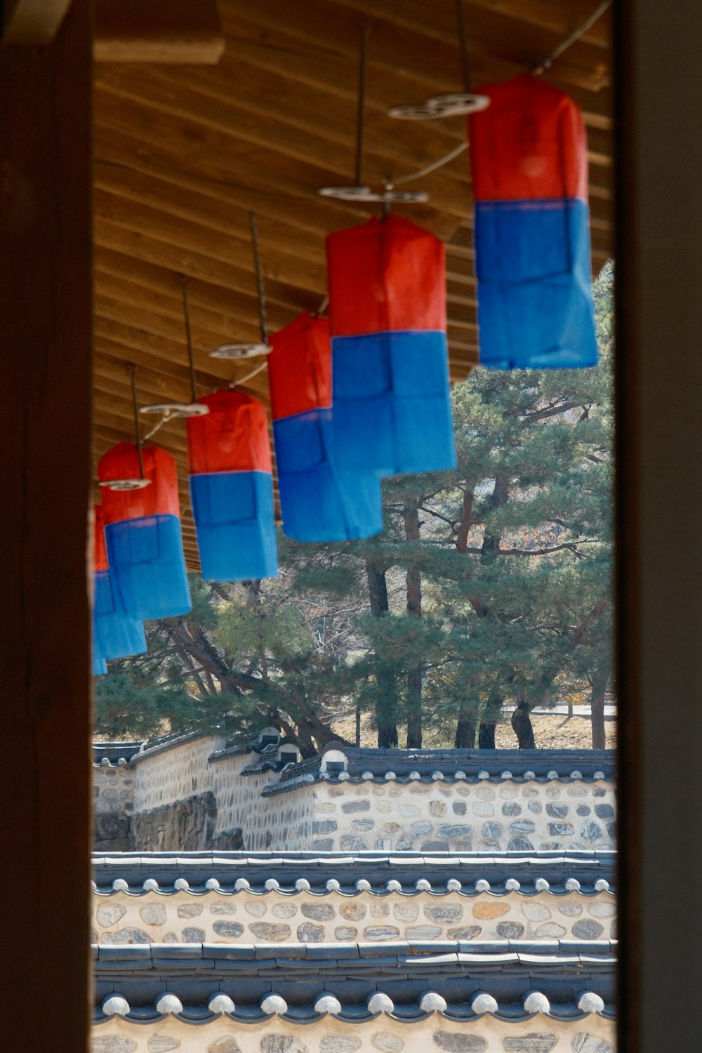 red and blue lanterns hanging from a roof