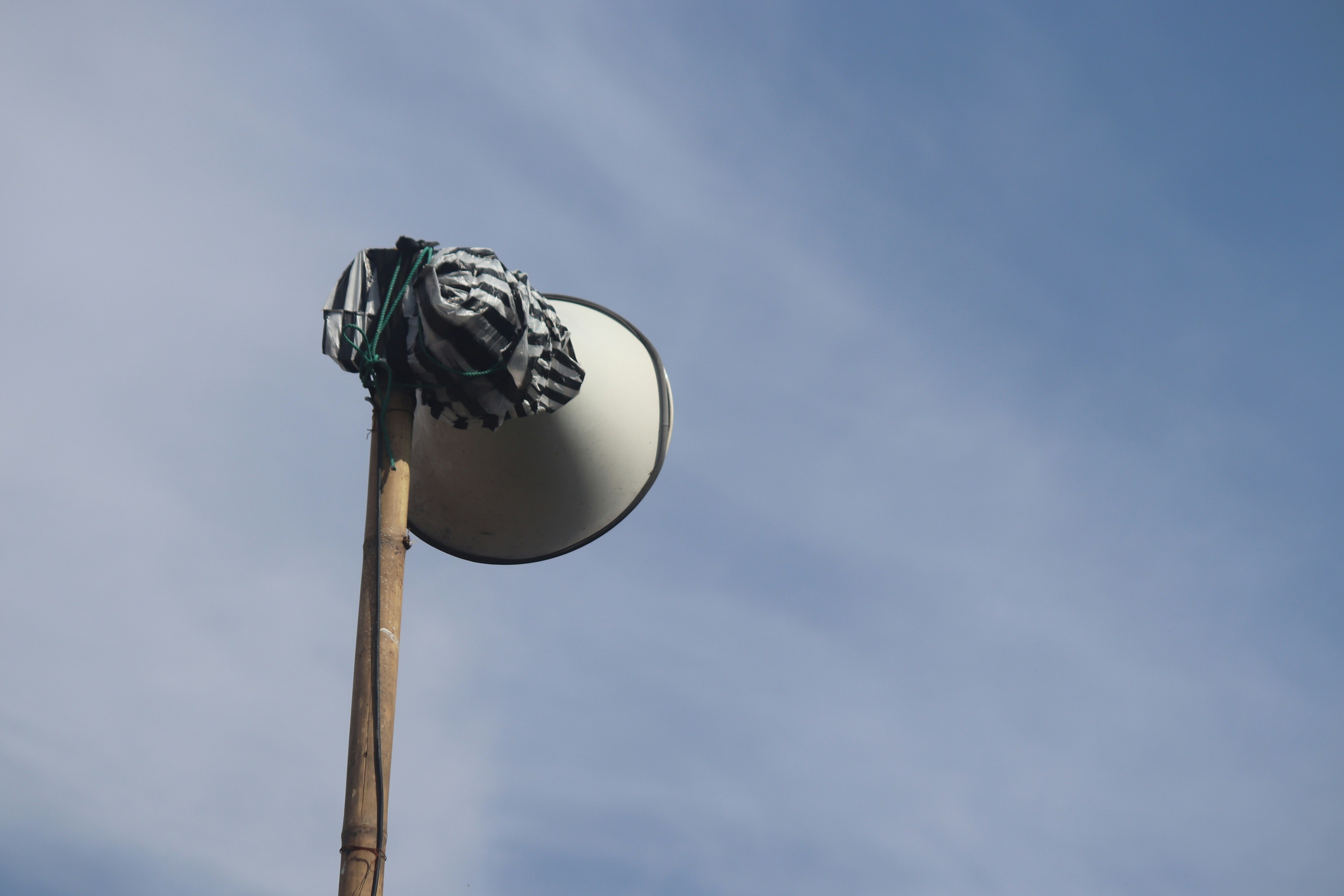 a close up of a street light with a sky background