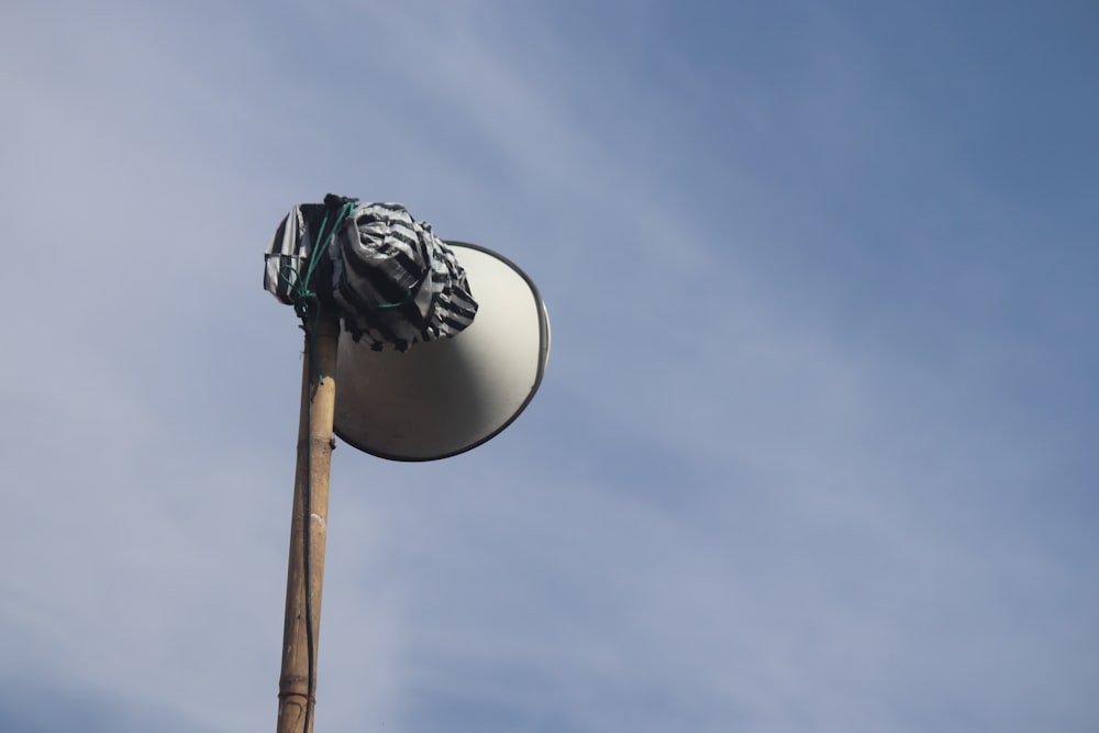 a close up of a street light with a sky background