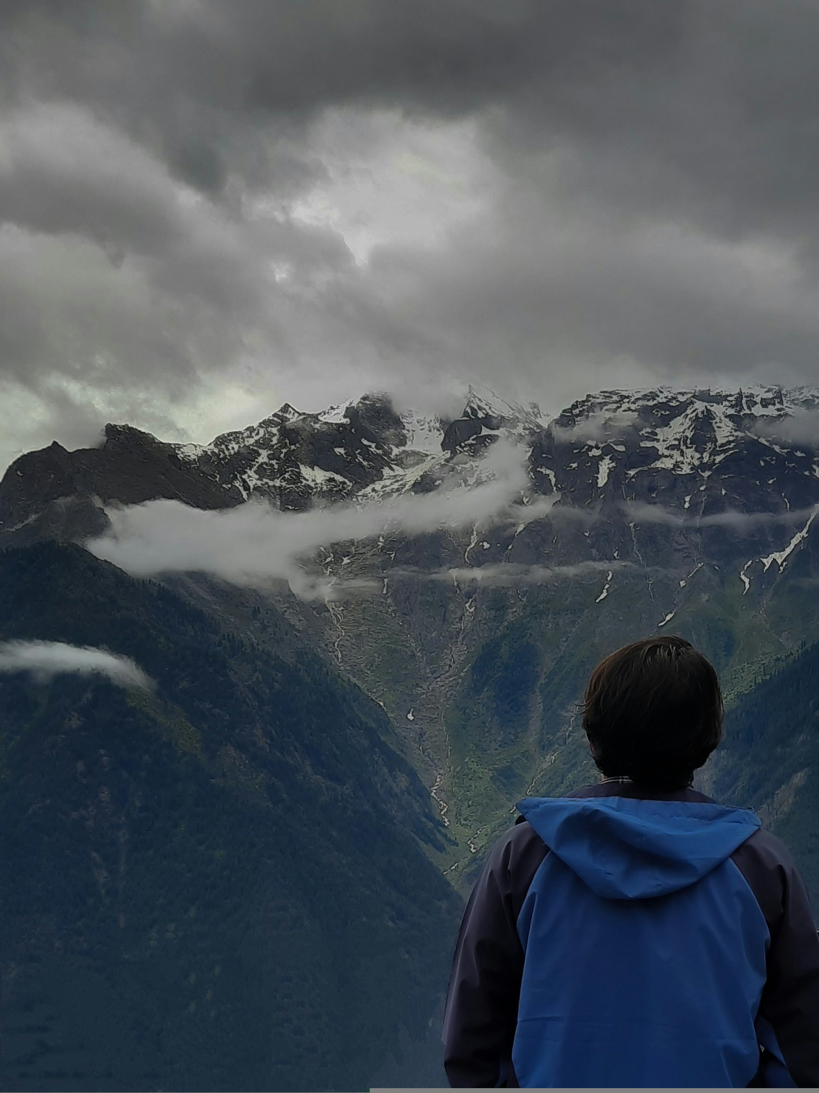A person standing in front of a mountain range