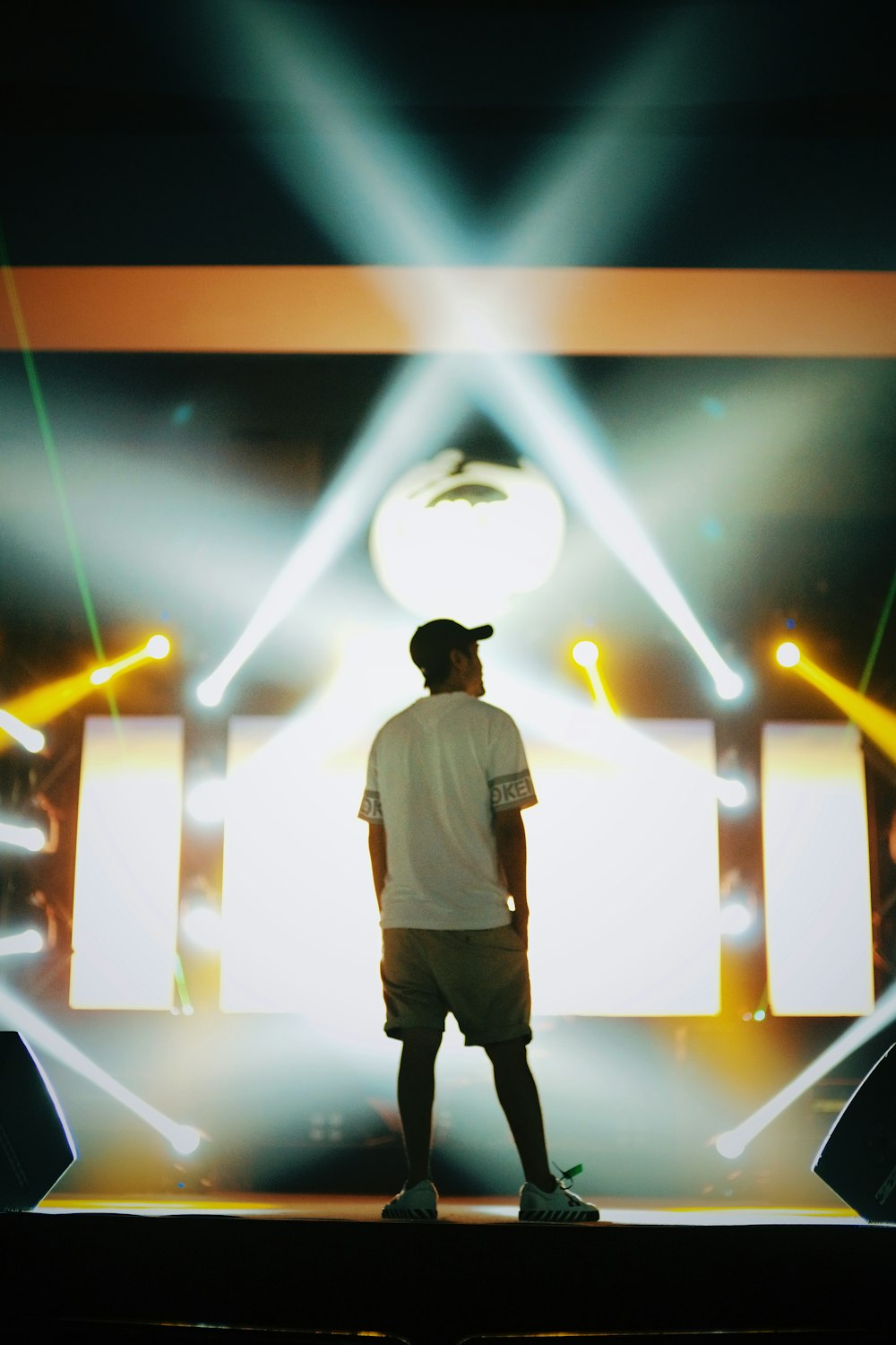 a man standing in front of a stage with lights