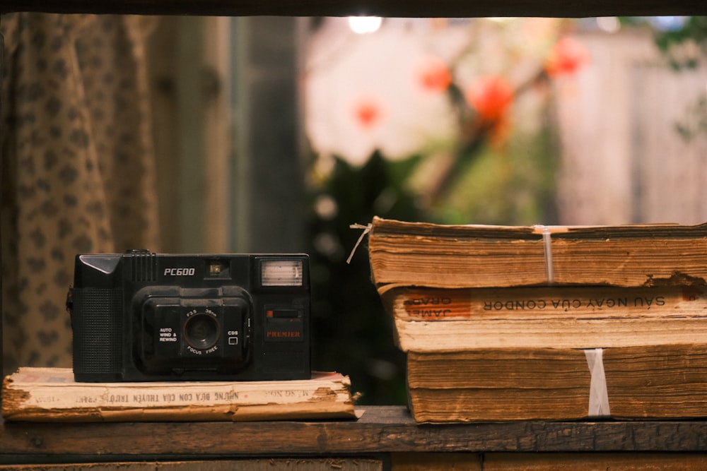 a camera sitting on top of a pile of books