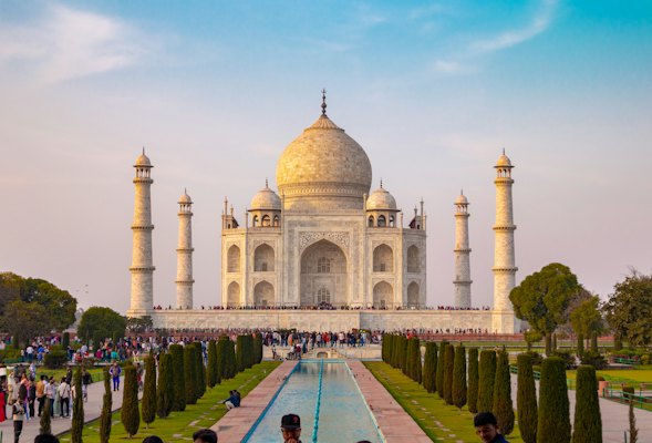 A group of people standing in front of a building — Agra & the Taj Mahal, India