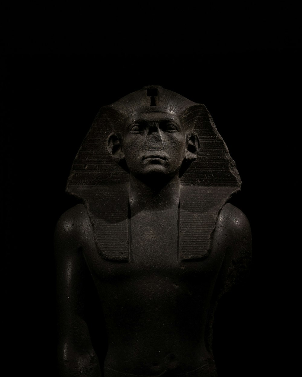 a black and white photo of an egyptian statue