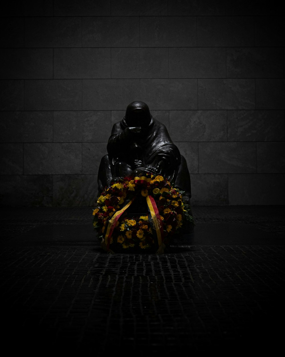 a statue of darth vader sitting in front of a wreath