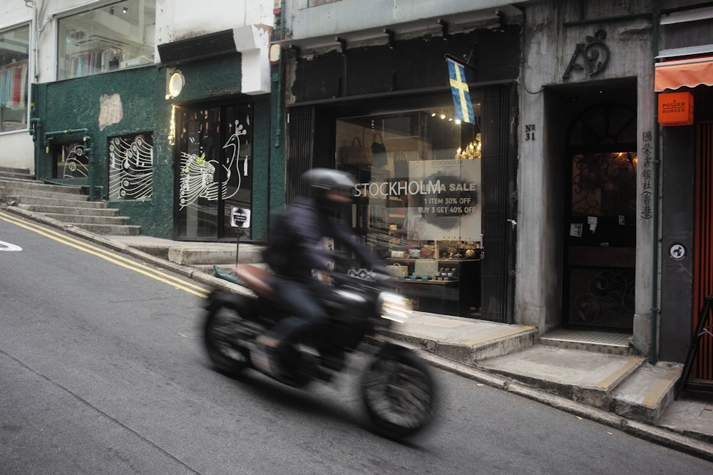 a man riding a motorcycle down a street