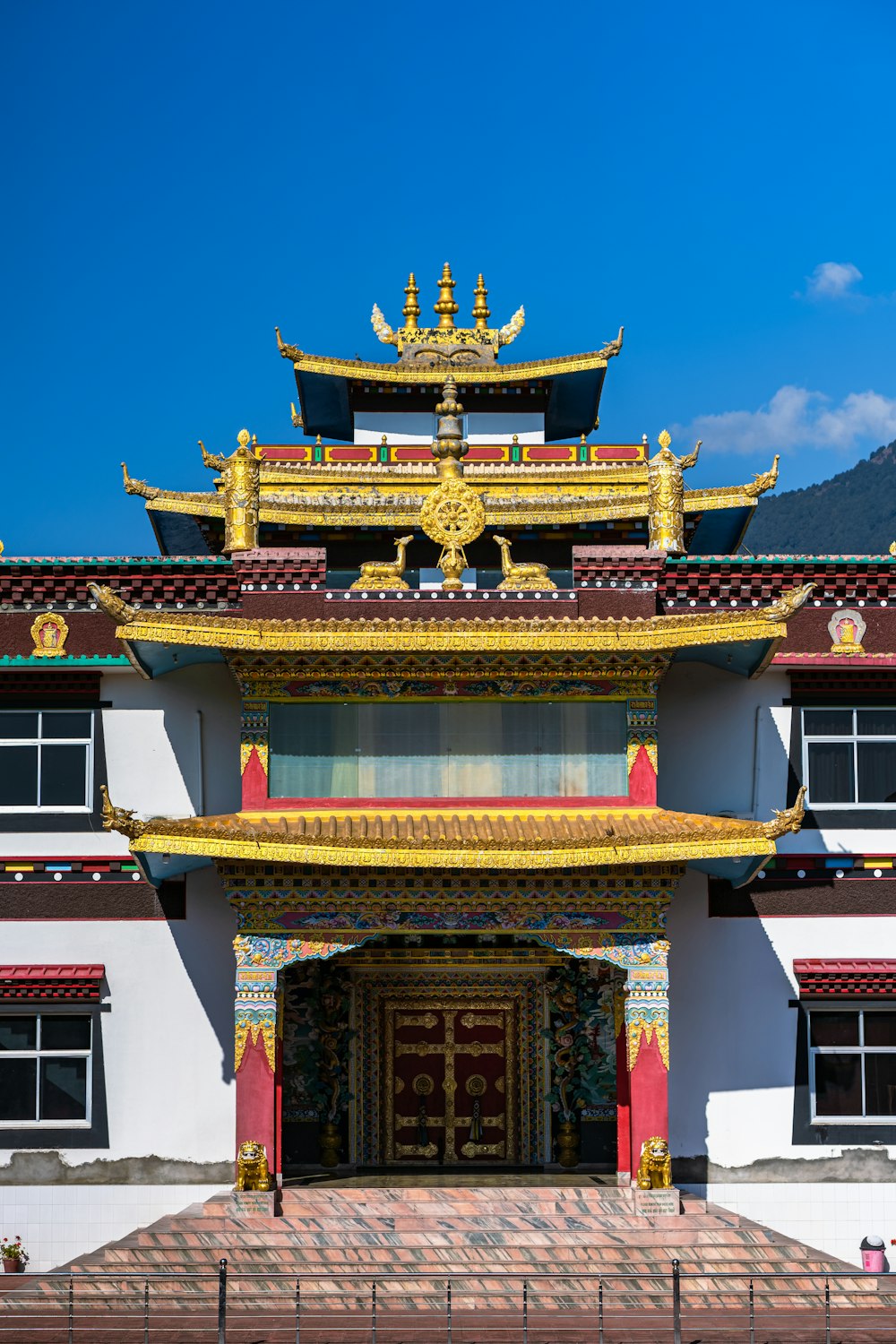 a white building with a yellow and red roof