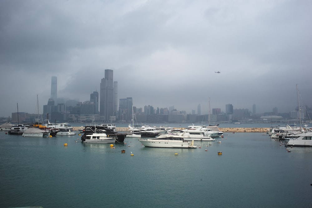 a harbor filled with lots of boats under a cloudy sky