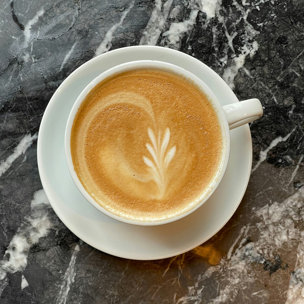 a cup of coffee on a marble table