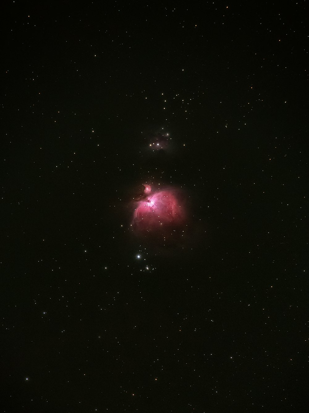 a very bright pink object in the middle of the night sky