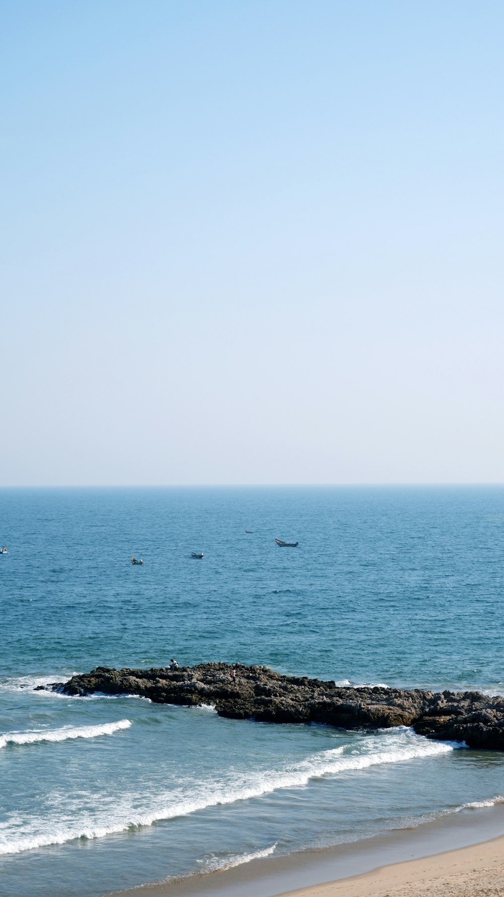 a group of boats floating on top of a large body of water