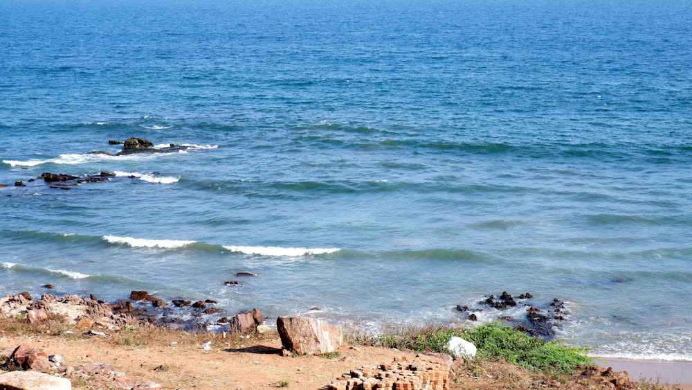 a view of a body of water with rocks in the foreground