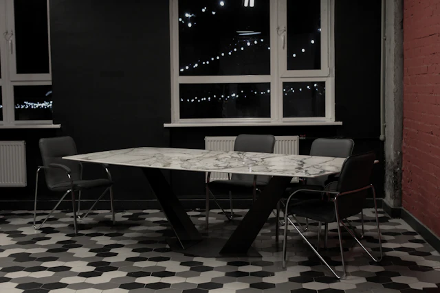 A black and white table and chairs in a room