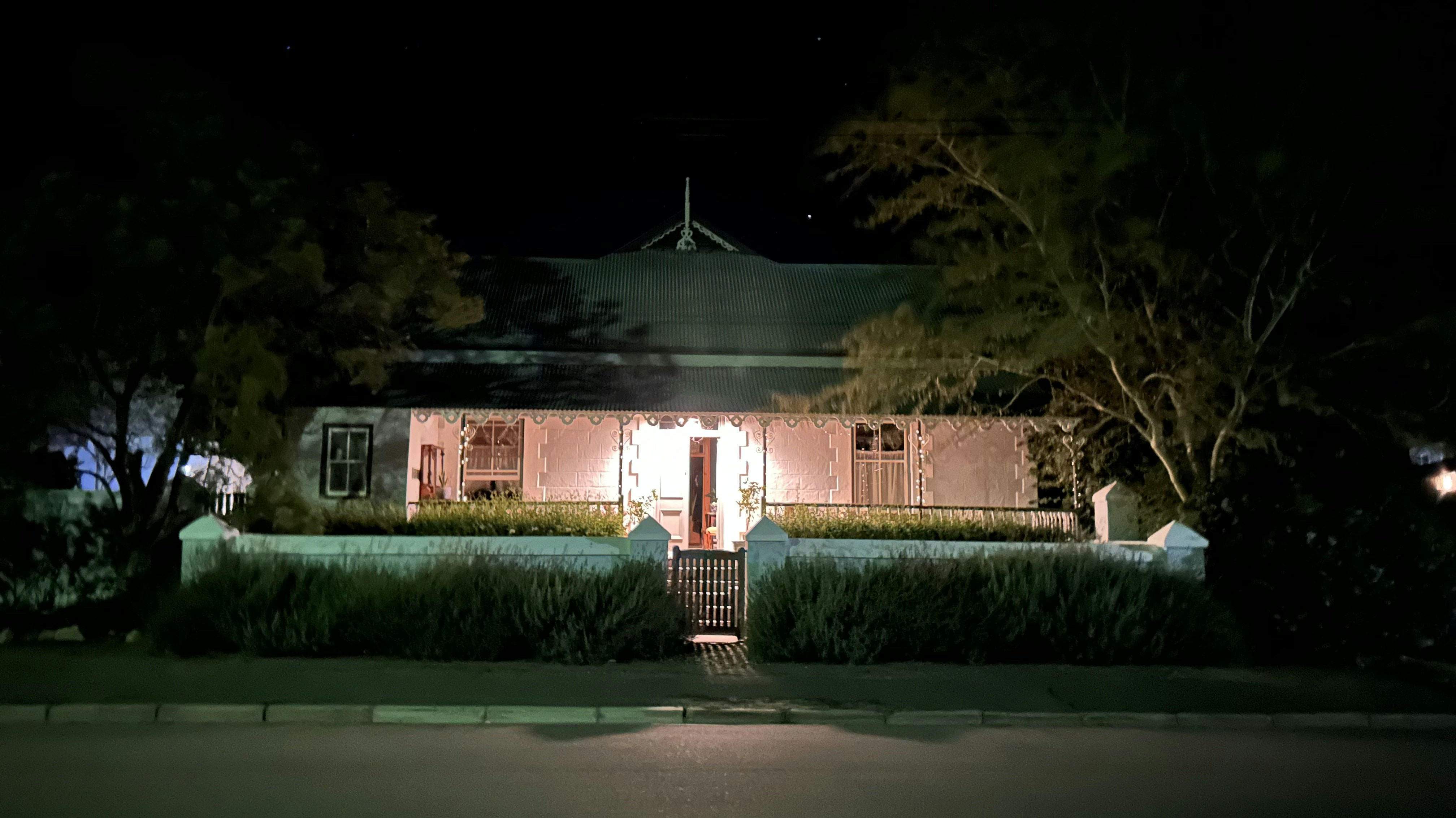 A house lit up at night with a gate photo – Free City Image on Unsplash