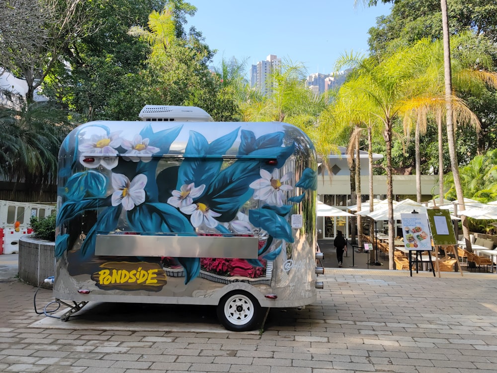 a trailer with flowers painted on the side of it