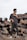 a man standing on top of a pile of metal pipes