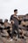 a man standing on top of a pile of metal pipes