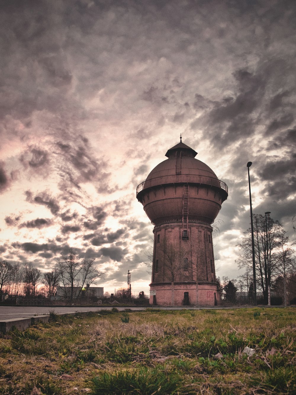 a very tall tower sitting in the middle of a field