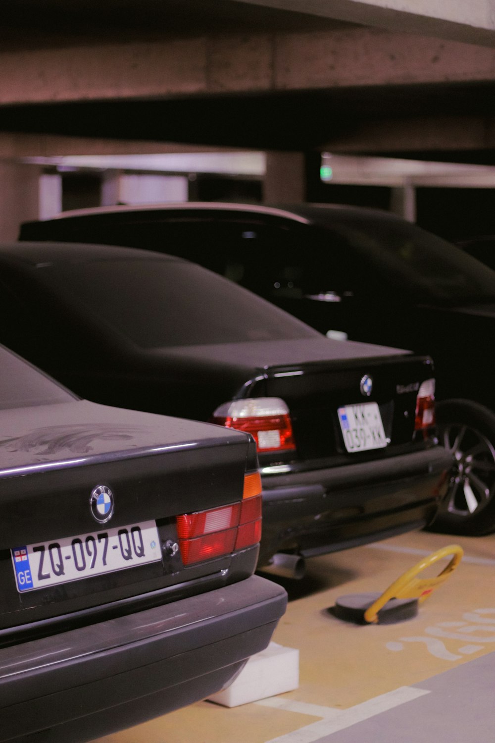 a row of parked cars in a parking garage