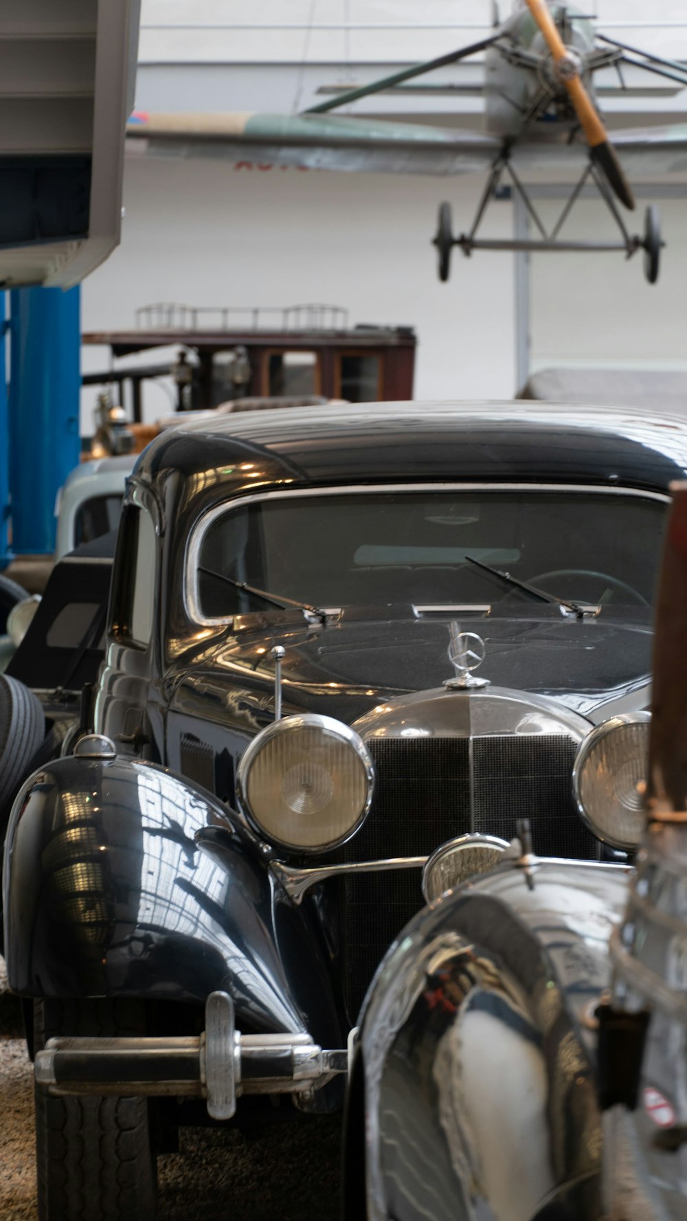 a row of classic cars parked in a garage