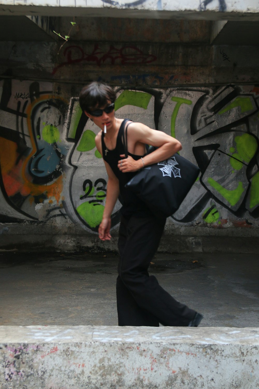 a woman walking down a street carrying a black bag