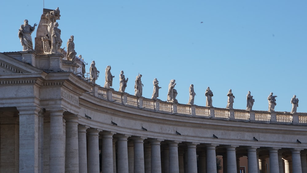 a group of statues on top of a building