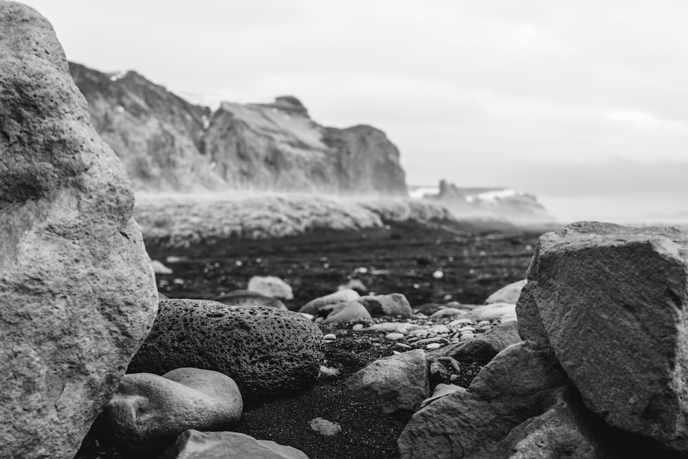 a black and white photo of rocks and water