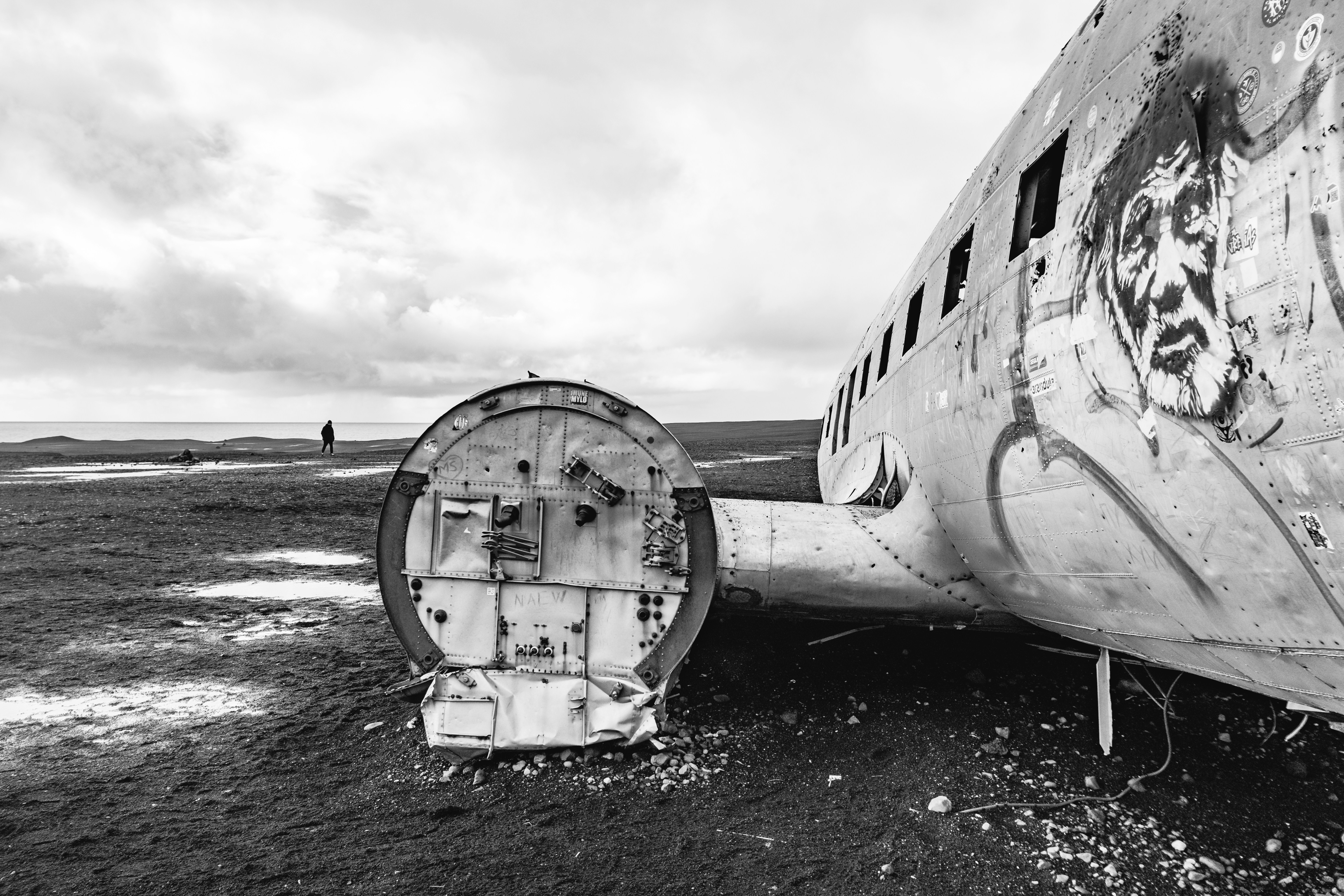 an old airplane sitting on top of a dry grass field, 