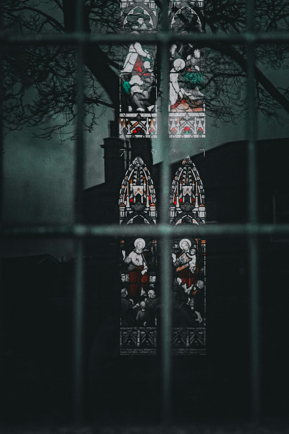 a clock tower seen through a window at night