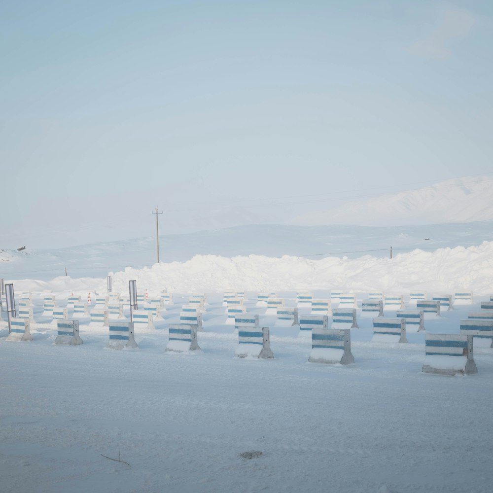 a bunch of benches that are in the snow