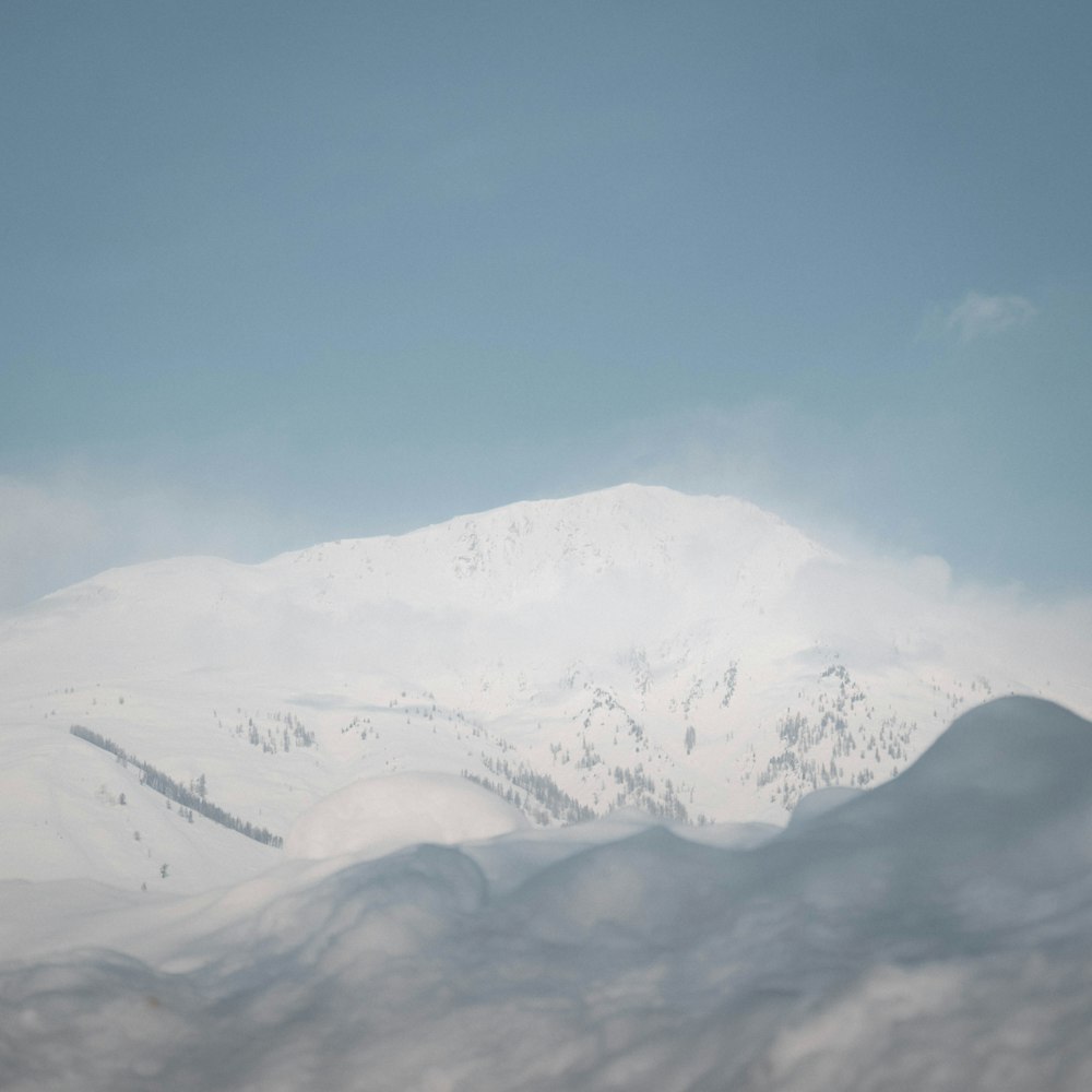 a mountain covered in snow under a blue sky