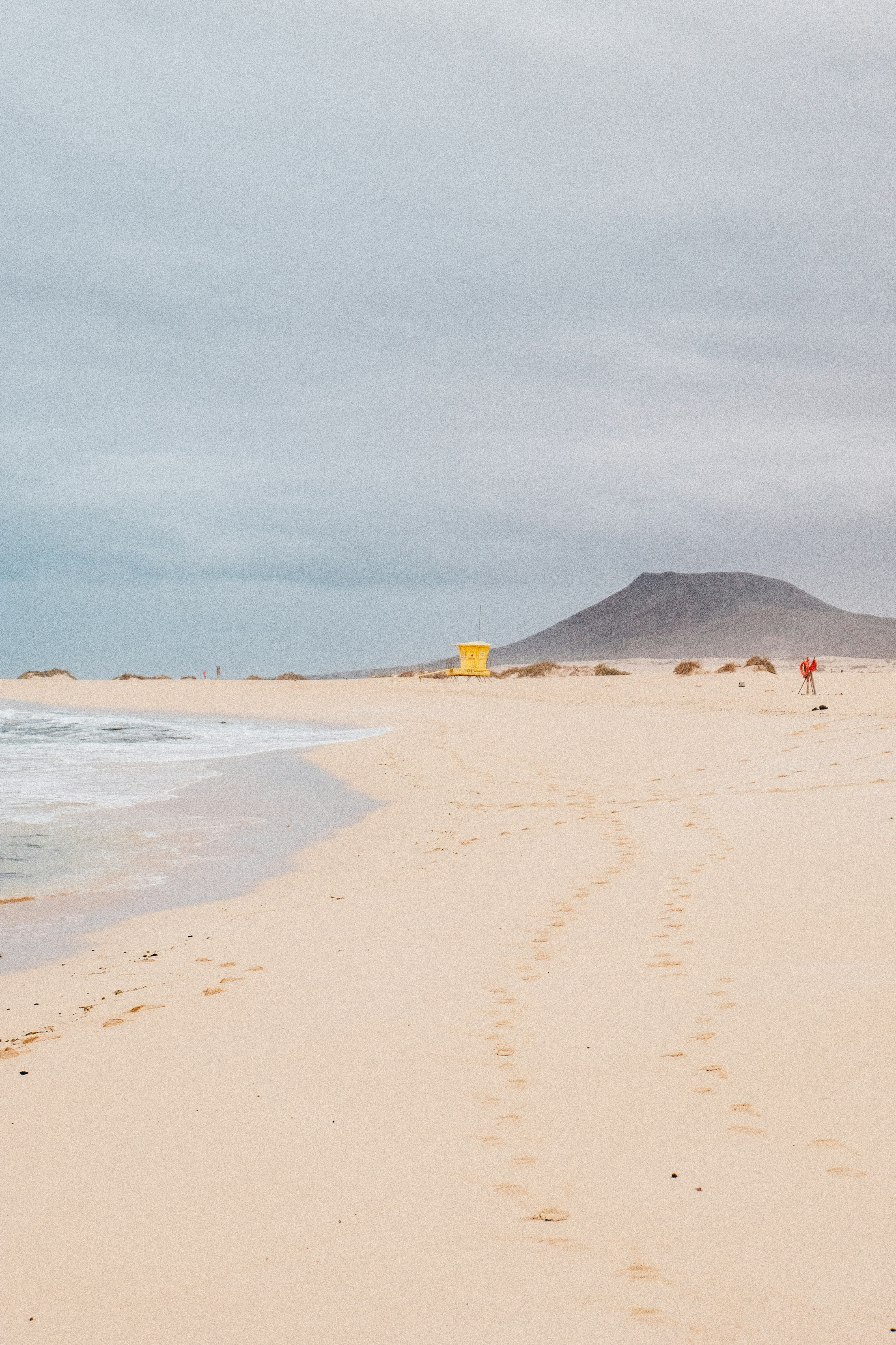 A sandy beach with footprints in the sand
